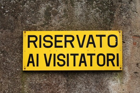 Reserved for visitor, yellow sign on an old wall (Reserved for visitors in English)の写真素材