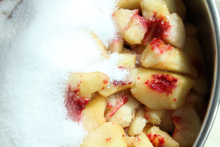 Sliced peaches and white sugar. Cooking of peach jam or marmalade.の写真素材
