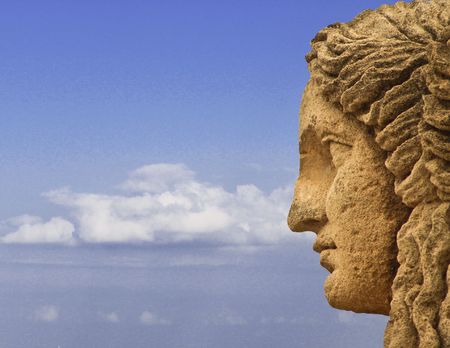 Mythological statue face profile on sky backgroundの写真素材