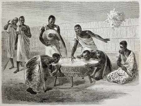 Old illustration of native Ugandan Africans drinking millet beer from a big common recipient. Created by Bayard and Dumont, published on Le Tour du Monde, Paris, 1864のeditorial素材