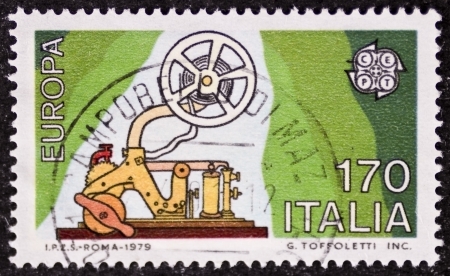 ITALY  CIRCA 1979: a stamp printed in Italy celebrates the European Idea showing an old telegraph machine. Italy, circa 1979のeditorial素材