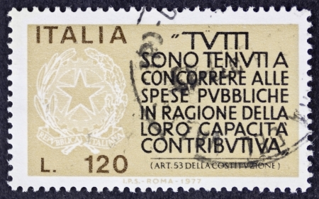 ITALY CIRCA 1977: a stamp printed in Italy celebrates  Italian Fiscus showing an article of Italian Constituion about obligation to contribute. Italy, circa 1977のeditorial素材