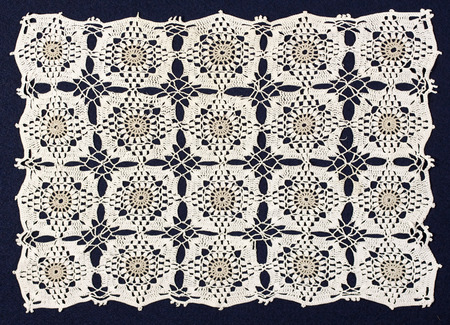 Handmade doily on blue background
