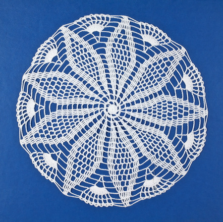 Handmade doily on blue backgroundの写真素材