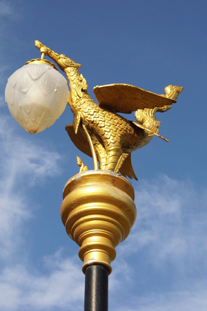 Golden swan street lamp in Thailand and blue skyの写真素材