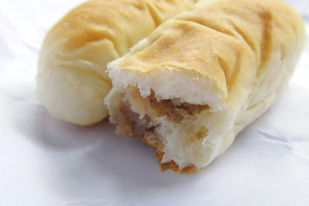 Bread filling with seasoned minced pork on paper