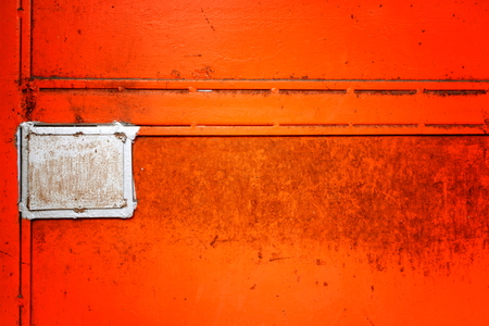Old metal door background in orange colorの写真素材