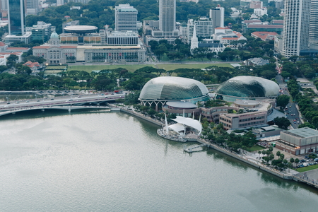 SINGAPORE - APRIL 14, 2017 : Esplanade Theatre view on Anderson Bridge, foreground is Singapore river and esplanade drive, in background are skyscraper.のeditorial素材