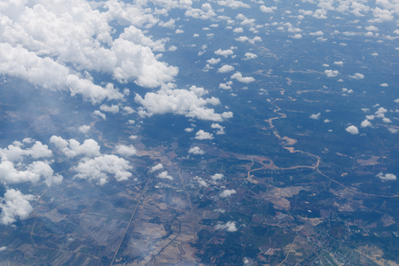 Aerial view from airplane window with forest and riverの写真素材