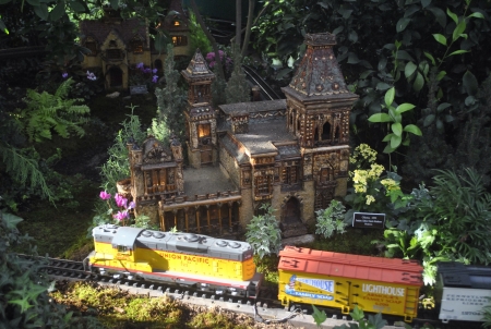 Miniature trains run around miniature buildings on display at the New York Botanical Gardenの素材