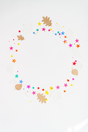 round frame with color star and autumn leaves on white backgroundの写真素材