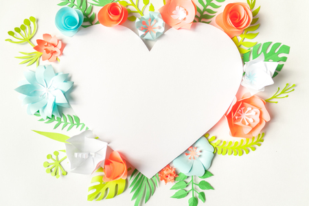 Festive flower composition with color paper flowers with greeting card on the white background. Flat lay, overhead view, top viewの写真素材