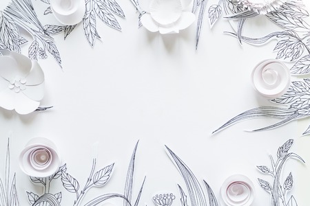 3d white paper flowers with painted leaves and stems on the white backgroundの写真素材