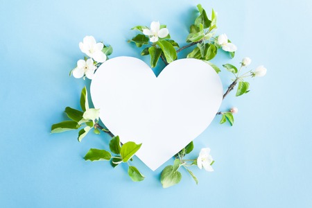 Heart frame with blossom apple on blue background. Copy spaseの写真素材