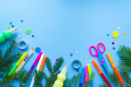 Christmas and new year, stationery, surrounded by fir branches on blue backgroundの写真素材