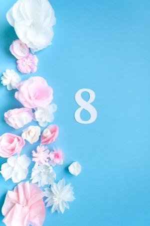 March 8 Women's Day card with paper flowers on blue background. Cut from paper.