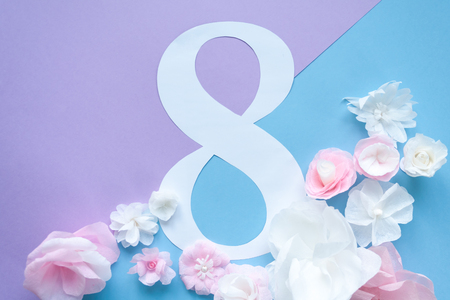 March 8 Women's Day card with paper flowers on blue background. Cut from paper.の写真素材