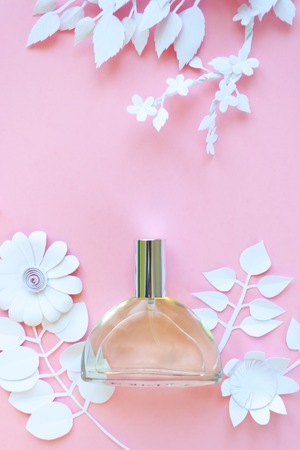 Flower arrangement. Flowers, fragrance, perfume on pink background. Cut from paper