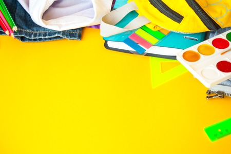 school fees, colorful pencils scissors on yellow background, space for text, flat lay, back to...