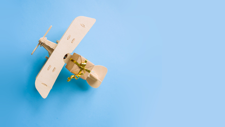 wooden childrens plane on a blue backgroundの写真素材