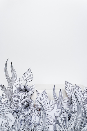 Mock-up for cosmetics. Concept natural herbal cosmetics with drawing paper flowers with painted leaves and stems on white backgroundの写真素材