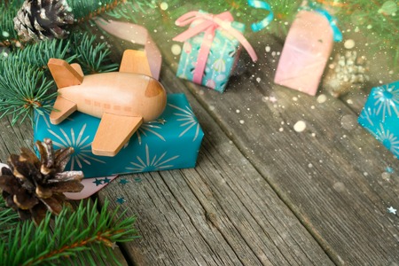 Merry Christmas and Happy new year. Child airplane with branches firtree, gifts, pine conesの写真素材