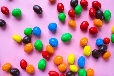 Tasty colorful candies on pink background, top viewの写真素材