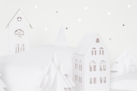 Winter wonderland made of white paper. Christmas tree of white paper decorated with a gold star. Christmas holidays conceptの写真素材