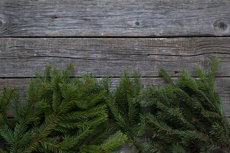 Christmas and Happy New Year holiday background with natural fir spruce, on wooden background, Winter Greeting Card concept with copy space for text. Holiday bannerの写真素材