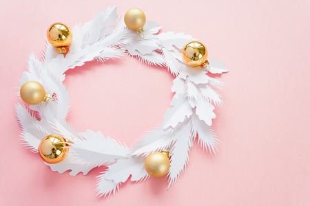 Merry Christmas and Happy New Year. Christmas wreath made of white paper with gold ballsの写真素材