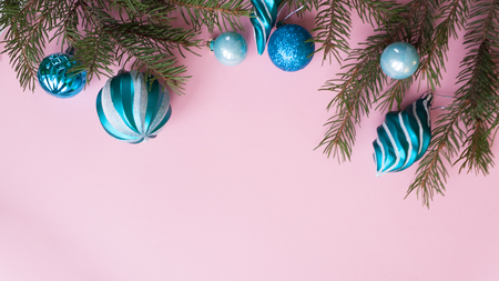 Merry Christmas and Happy New Year. Christmas Card Festive with green Fir Branches and Holiday Object on pink Background.の写真素材
