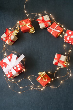 Merry Christmas and Happy New Year. Christmas Card Festive with green Fir Branches and Holiday Object on black Background.の写真素材