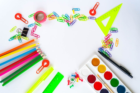 Heart frame lined with stationery on white background