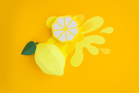 Fruit made of paper. Yellow background. There's room for writing. Tropics. Flat lay. Lemon on trendy modern background. Yellow summer conceptの写真素材