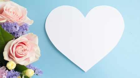 Heart frame  and flower  bouquet on blue backgroundの写真素材