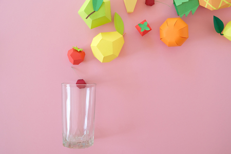 different exotic fruits made of paper on pink background. fruits fly into the glass. Advertising of drink, juice, smoothie, summer conceptの写真素材