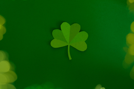 Happy St.Patrick's Day, shamrock cut from paper on white background, text greeting card raster