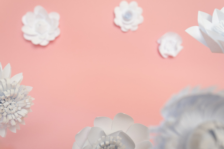 White paper flowers on pink background. Floral background cut from paperの写真素材