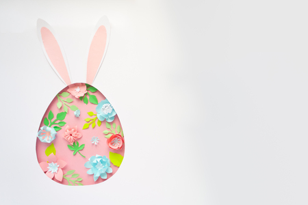 Easter egg made of paper flowers on pink background. Cut from paper.の写真素材