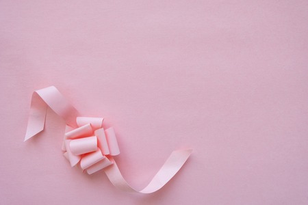 frame with pink ribbon on pink background.の写真素材