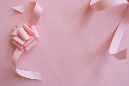 frame with pink ribbon on pink background.の写真素材