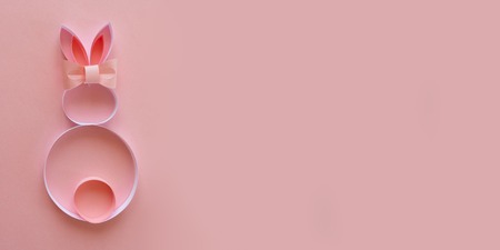 Happy easter. Cute paper easter bunny on pink backgroundの写真素材