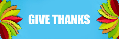 multi-colored turkey tail made of paper on a blue background. Thanksgiving conceptの写真素材