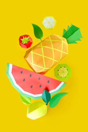 the fruits of paper levitated in the air on yellow background. Handmade paper artの写真素材