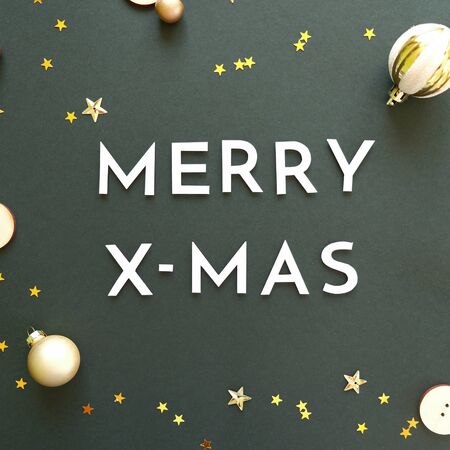 Merry christmas and happy new year wiyh gold decoration on black background colorful glass balls on...