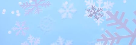 Happy new year and merry Christmas. Winter background. White snowflakes cut from white paper on a...