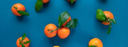 Pattern with orange tangerine with leaves on blue classic color background. Concept of healthy food,...