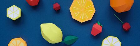 Exotic fruits made of paper on classic blue background. Vitamin concept