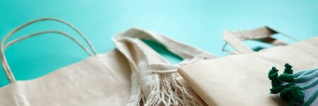 String bag, cotton bag and paper bags for free plastic purchases on a neo-mint background. Zero...