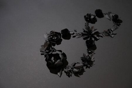 March 8 Women's Day card with black paper flowers on classic black background. Cut from paper.